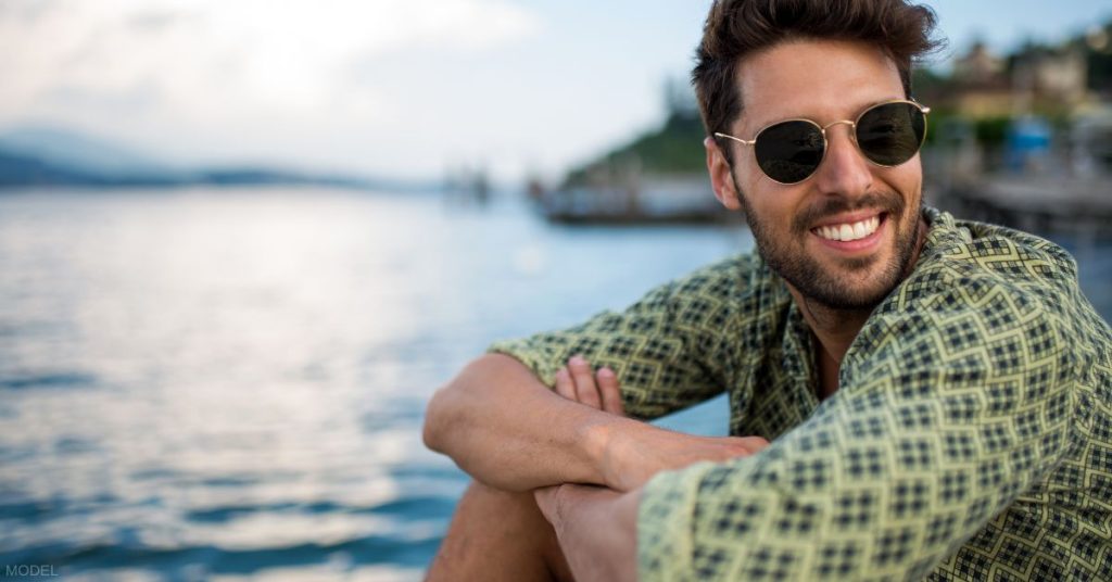 Handsome man wearing sunglasses smiling (model)